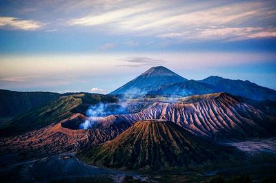 View of volcanic landscape against cloudy sky