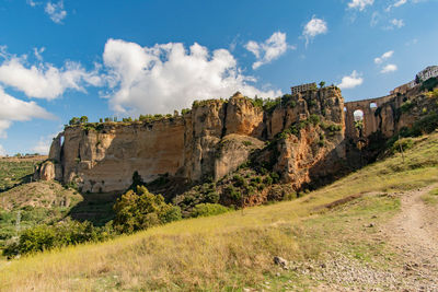 Panoramic view of stone wall against sky