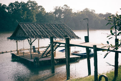 Empty benches by plants against sky