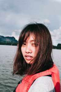 Portrait of woman against lake