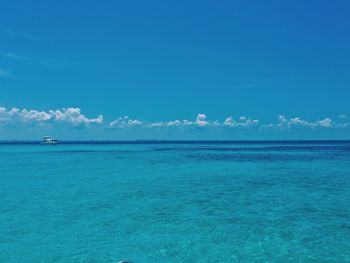 Scenic view of sea against blue sky