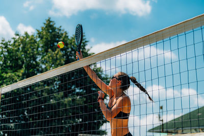 Beach tennis player at the net