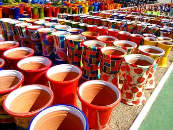 Row of multi colored chairs at market stall