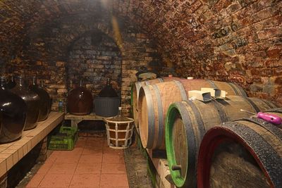 Vintage demijohns in a traditional wine cellar. demijohn wine bottles and wooden wine barrels