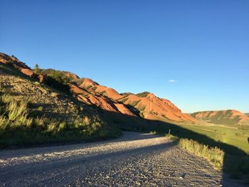 Scenic view of mountains against clear blue sky