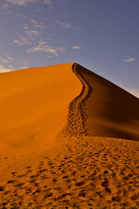 Scenic view of desert against sky during sunset