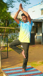 Young man doing yoga outdoors with amazing background.