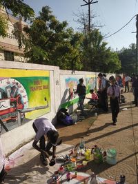 Group of people against graffiti on wall