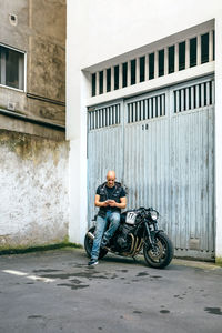 Man riding bicycle on road in city