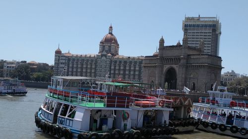 Boats in river with buildings in background