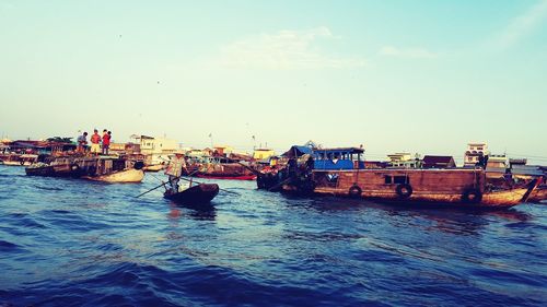 Boats moored on sea against sky