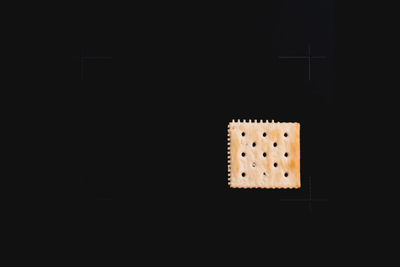 Close-up of illuminated lamp over black background