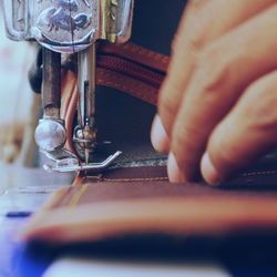 Cropped image of hand sewing textile