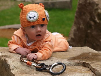 Close-up of cute baby boy sitting outdoors