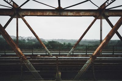 Low angle view of rusty metal against sky