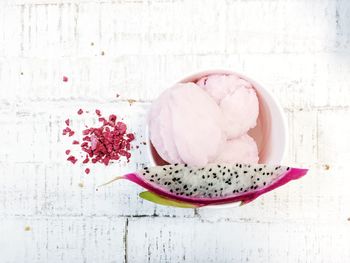 High angle view of pitaya and ice cream in container on table