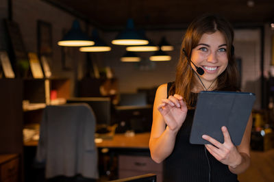 Portrait of smiling young woman digital tablet