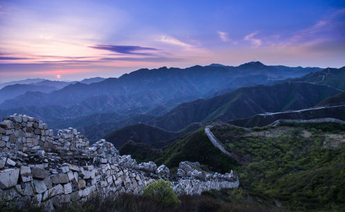 Scenic view of mountains against cloudy sky