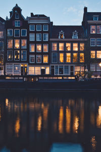 Reflection of buildings on river at dusk