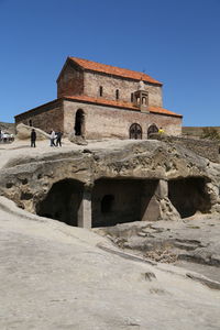 Low angle view of historical building against blue sky