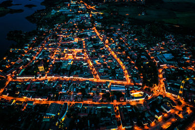 High angle view of illuminated buildings in city at night