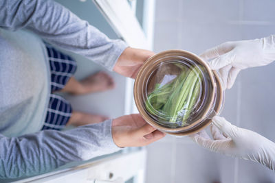 Midsection of woman holding umbrella