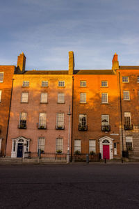Residential buildings against sky at dusk