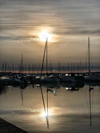 Sailboats in marina at sunset