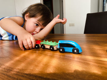 Boy playing with toy blocks on table