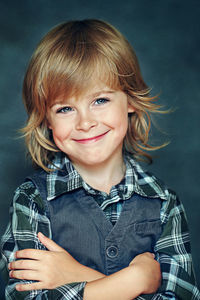 Portrait of smiling boy holding camera