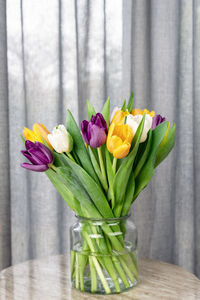 Bouquet of fresh bright colorful tulips on a side table.