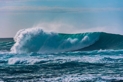 Scenic view of sea waves against sky