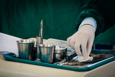 Cropped image of dentist hand holding cotton at office