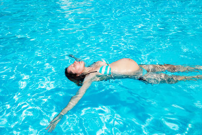 High angle view of woman swimming in pool