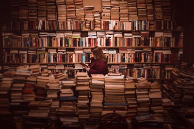 Rear view of woman reading book