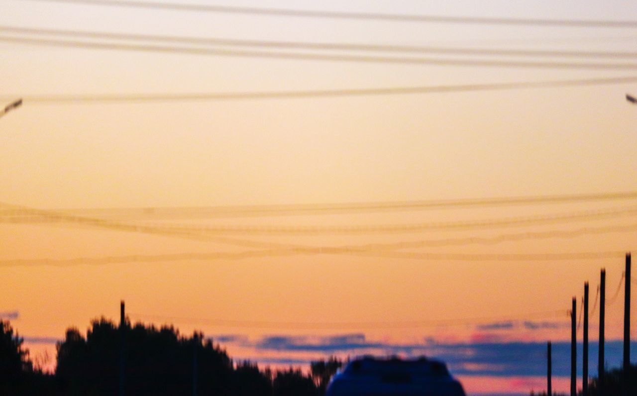 SILHOUETTE CITYSCAPE AGAINST SKY AT SUNSET