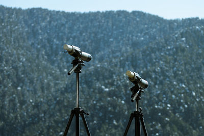 Telescope against mountains