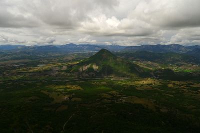 Scenic view of mountains against cloudy sky