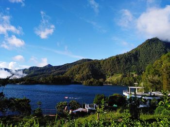 Scenic view of lake and mountains against sky