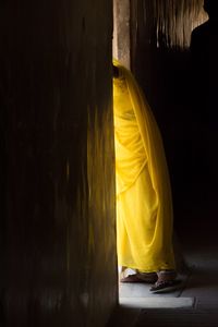 Low section of woman peeking from doorway of amer fort