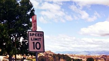 Road sign against sky