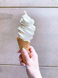 Close-up of hand holding ice cream cone