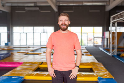 Portrait of young man standing at home