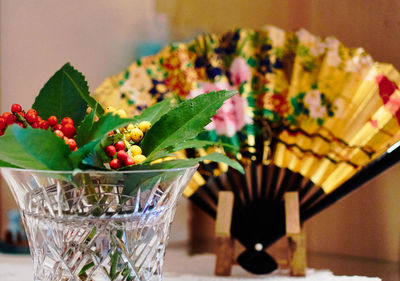 Close-up of berries by hand fan on table