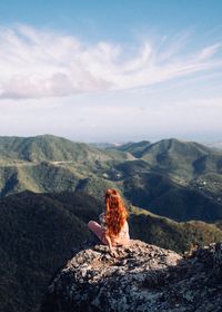 Lizard on rock against sky