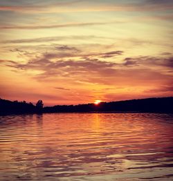 Scenic view of lake against romantic sky at sunset