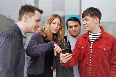 Two young men looking at friends