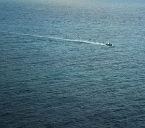 Scenic view of boat crossing the sea