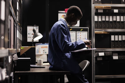 Side view of man working at airport