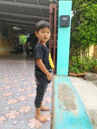 Full length portrait of cute boy standing outdoors